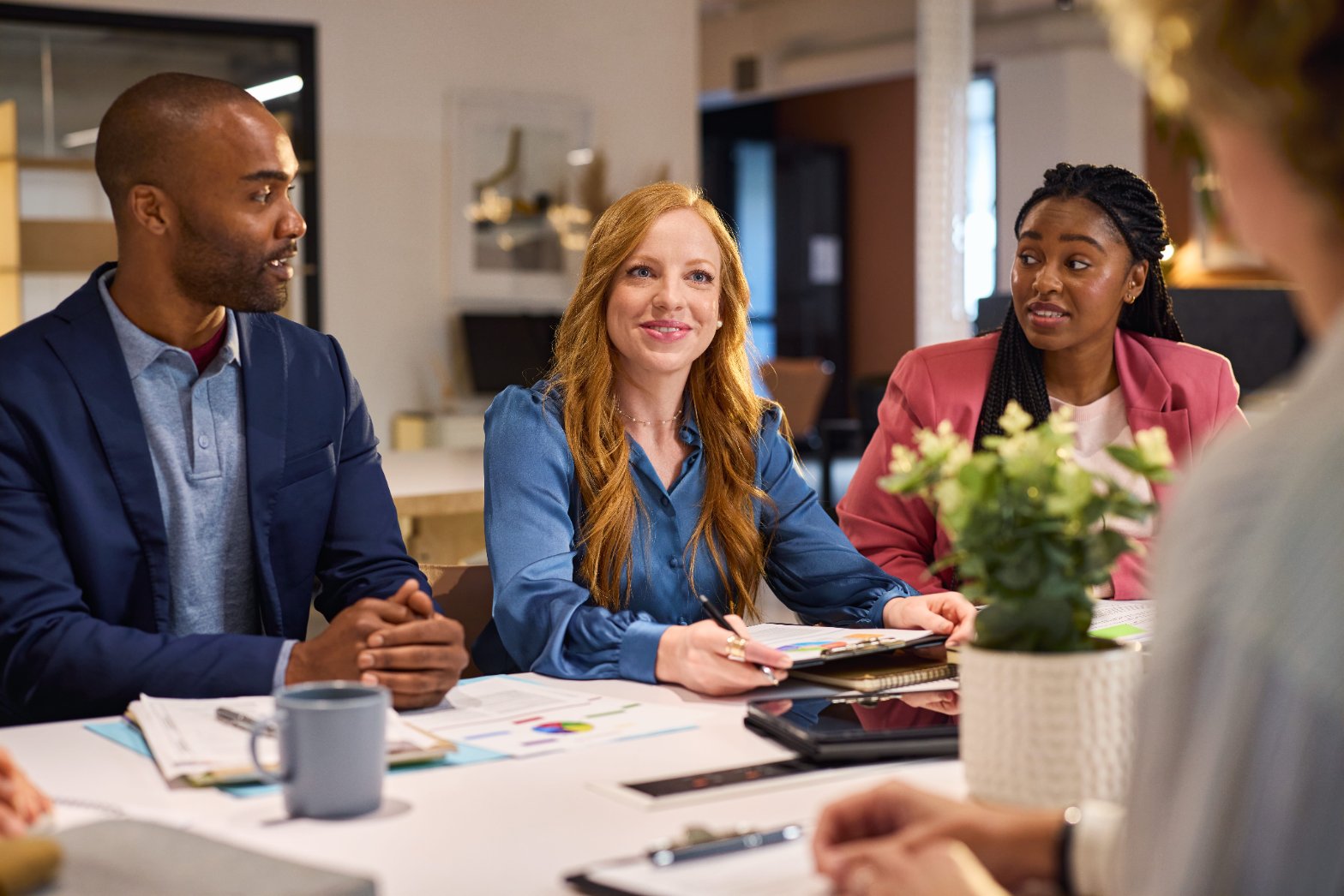 Enthusiastic professionals collaborating in a modern workspace — leadership development in action